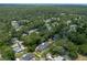 Overhead view of a residential area with numerous houses, lush trees, and well-manicured lawns at 1620 20Th St, Orange City, FL 32763