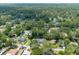 An aerial view of a neighborhood showcases lush green trees and well-spaced homes at 1620 20Th St, Orange City, FL 32763