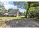 Backyard featuring mature trees, an outdoor playset and stairs to a balcony at 1620 20Th St, Orange City, FL 32763