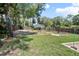 Spacious backyard with a garden area and mature trees providing ample shade at 1620 20Th St, Orange City, FL 32763