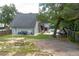 View of a spacious backyard with a pool, garden area, and mature trees, perfect for outdoor living at 1620 20Th St, Orange City, FL 32763