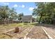 Backyard featuring a garden area with a potting station surrounded by mature trees at 1620 20Th St, Orange City, FL 32763