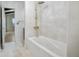 Bathroom featuring a white soaking tub with tile surround and modern fixtures at 1620 20Th St, Orange City, FL 32763