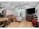 Bright open floorplan bedroom with large TV, natural light and seating at 1620 20Th St, Orange City, FL 32763