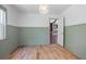 Dining room with light green trim, wood floors, and a glimpse into the living area at 1620 20Th St, Orange City, FL 32763