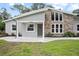 Beautifully updated home with stone accents, a modern door, and manicured lawn at 1620 20Th St, Orange City, FL 32763