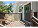 Cozy front porch featuring wicker chairs, a welcome mat, and a wreath on the front door at 1620 20Th St, Orange City, FL 32763