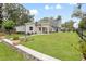 A well-maintained front yard features lush green grass and stone landscape accents at 1620 20Th St, Orange City, FL 32763