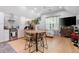 Open living area featuring modern kitchen, dining area, and comfortable seating under a vaulted ceiling at 1620 20Th St, Orange City, FL 32763