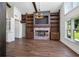 Inviting living room featuring a brick fireplace, built-in shelves, and abundant natural light at 1620 20Th St, Orange City, FL 32763