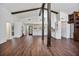 Open-concept living room and kitchen with wood beams, and hardwood floors at 1620 20Th St, Orange City, FL 32763