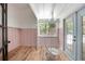 Inviting sunroom with wooden floors, hanging chair, pastel wainscoting, and natural light at 1620 20Th St, Orange City, FL 32763