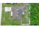 Aerial view of the property showing the roof, backyard, screened porch, and surrounding greenery at 1725 12Th St, Orange City, FL 32763