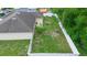Aerial view of a spacious backyard with a white fence and green grass, ready for outdoor enjoyment at 1725 12Th St, Orange City, FL 32763