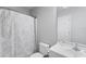 Clean, neutral bathroom with a patterned shower curtain, updated sink, and tiled floors at 1725 12Th St, Orange City, FL 32763