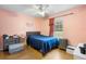 Cozy bedroom with a dark-blue comforter, natural light, and hard surface flooring at 1725 12Th St, Orange City, FL 32763