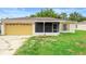 Charming single-story home with a large garage and screened porch in a quiet neighborhood with blue skies overhead at 1725 12Th St, Orange City, FL 32763