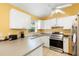 Bright kitchen featuring stainless steel appliances, white cabinetry, and neutral countertops at 1725 12Th St, Orange City, FL 32763