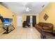 Bright living room with tile flooring, leather furniture, and a ceiling fan providing a comfortable space at 1725 12Th St, Orange City, FL 32763
