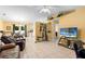 Open-concept living room featuring tile flooring, comfortable leather seating, and a view into the dining area at 1725 12Th St, Orange City, FL 32763