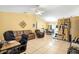 Spacious living room with tile floors, a leather sofa, and a dining area in an open layout at 1725 12Th St, Orange City, FL 32763
