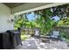 Relaxing backyard patio area with comfortable seating, lush greenery, and a grill, ideal for outdoor enjoyment at 1734 Magnolia Ave, Deland, FL 32724