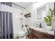 Bright bathroom with white tile, granite vanity, and shower-tub combination, perfect for modern living at 1734 Magnolia Ave, Deland, FL 32724