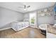 Bright bedroom with wood flooring, ceiling fan, and modern decor at 1734 Magnolia Ave, Deland, FL 32724
