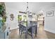Bright dining area featuring stylish decor, a modern light fixture, and an adjacent kitchen at 1734 Magnolia Ave, Deland, FL 32724