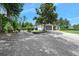 Long driveway leading to a well maintained home with mature trees, and a basketball hoop at 1734 Magnolia Ave, Deland, FL 32724