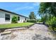 Back exterior of the home with a well maintained yard and wooded area at 1734 Magnolia Ave, Deland, FL 32724