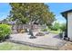 Backyard fire pit area with chairs and a sandy surface, creating an inviting outdoor gathering space at 1734 Magnolia Ave, Deland, FL 32724