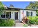 Inviting front entrance with decorative wreath, charming flower bushes, and an American flag at 1734 Magnolia Ave, Deland, FL 32724