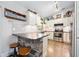 Bright kitchen with white cabinets, stone accent island, and stainless steel appliances at 1734 Magnolia Ave, Deland, FL 32724