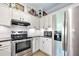 Kitchen features stainless steel refrigerator and range with sleek, modern countertops at 1734 Magnolia Ave, Deland, FL 32724