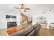 Bright living room with hard wood flooring, modern furniture, and a gorgeous wood feature wall at 1734 Magnolia Ave, Deland, FL 32724