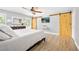 Spacious bedroom features wood flooring, a ceiling fan, and sliding barn doors at 1734 Magnolia Ave, Deland, FL 32724