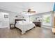 Light-filled main bedroom is spacious, offering hardwood flooring, and a ceiling fan at 1734 Magnolia Ave, Deland, FL 32724
