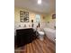 Inviting bathroom featuring a modern vanity, soaking tub, and wooden floors at 17531 Ne 139Th Ave, Fort Mc Coy, FL 32134