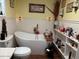 Cozy bathroom featuring a soaking tub, bear themed decor, and natural lighting at 17531 Ne 139Th Ave, Fort Mc Coy, FL 32134