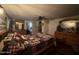 Spacious bedroom featuring rustic log furniture, a decorative quilt, and natural light at 17531 Ne 139Th Ave, Fort Mc Coy, FL 32134
