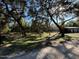 Landscaped lot with mature trees, brick driveway, shed, and home in the background at 17531 Ne 139Th Ave, Fort Mc Coy, FL 32134