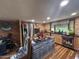 Open kitchen features a wooden accent wall, an island, a stainless steel refrigerator, and wood cabinets at 17531 Ne 139Th Ave, Fort Mc Coy, FL 32134