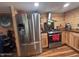 The kitchen features stainless steel appliances, wooden cabinets and walls, and modern lighting at 17531 Ne 139Th Ave, Fort Mc Coy, FL 32134