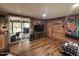 Cozy living room featuring wood walls, rustic decor, and a large painting at 17531 Ne 139Th Ave, Fort Mc Coy, FL 32134