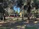 Lush wooded lot with a red shop and a utility trailer adding an element of utility to the serene setting at 17531 Ne 139Th Ave, Fort Mc Coy, FL 32134