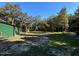 View of the grassy yard and trees and shed at 17531 Ne 139Th Ave, Fort Mc Coy, FL 32134