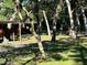 Spacious wooded yard with picnic table and other features with dappled sunlight throughout the property at 17531 Ne 139Th Ave, Fort Mc Coy, FL 32134