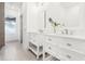 Modern bathroom features double vanities with marble countertops and a large mirror at 1856 9Th Ave, Deland, FL 32724