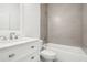 Modern bathroom with a marble vanity and grey tile shower and tub at 1856 9Th Ave, Deland, FL 32724